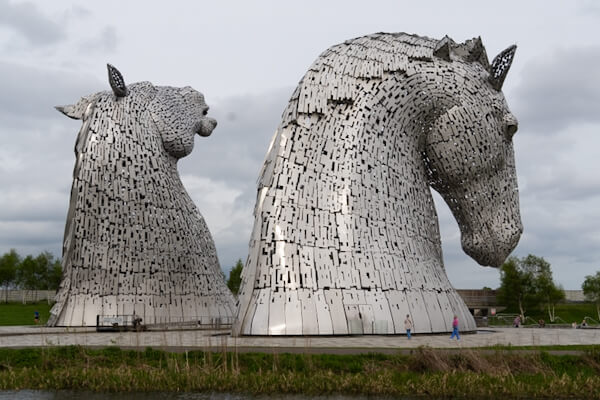 Kleine Menschen vor riesigen Kelpies